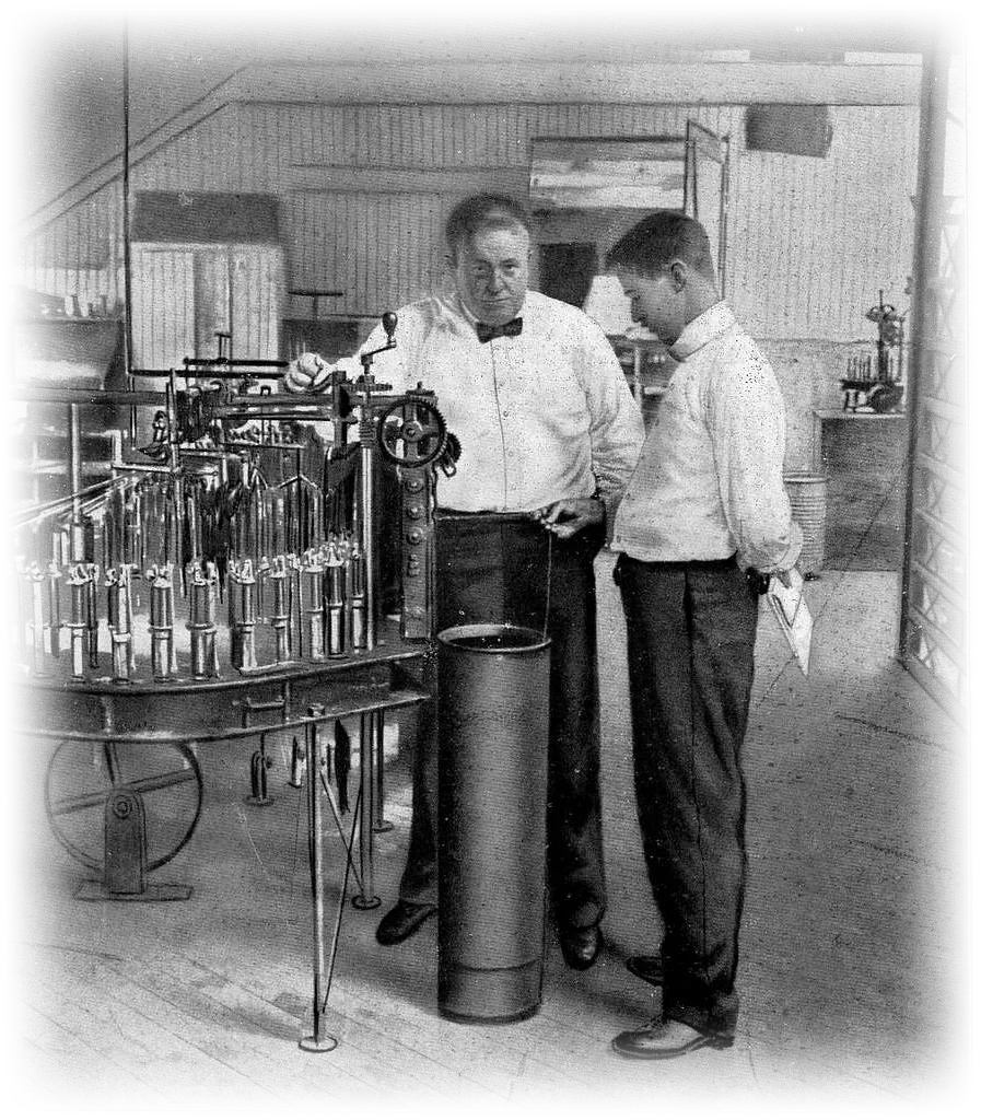 Frank Gilbreth observing a worker at a factory machine, photographed during a motion study.